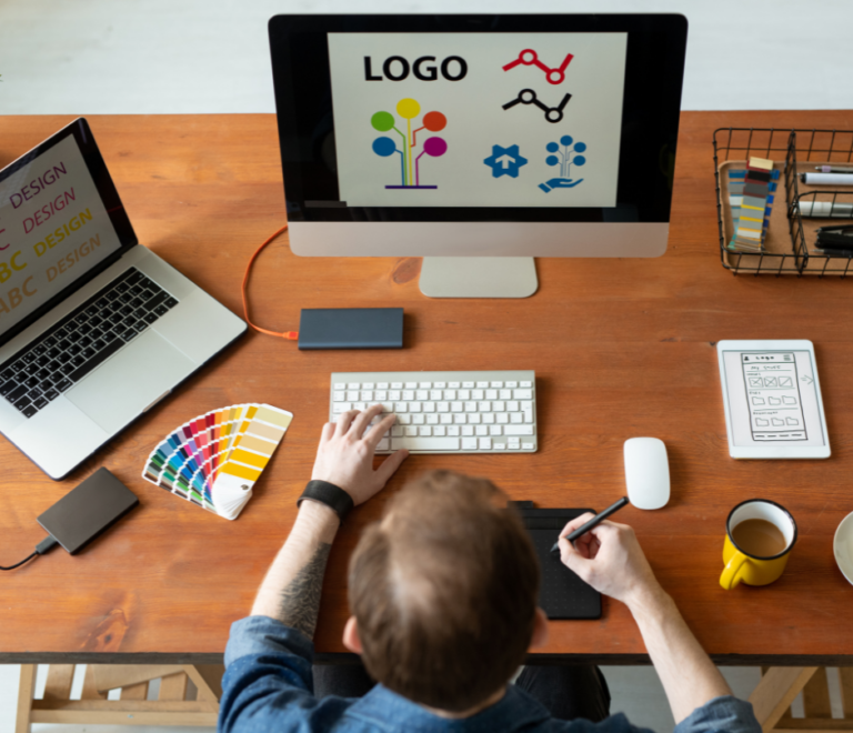 a logo designer works at his desk